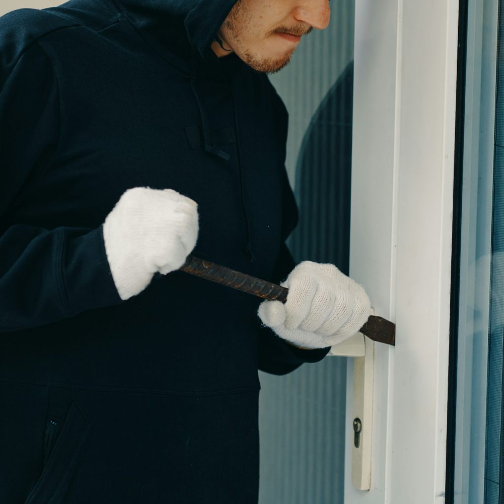 Burglar with Crowbar Breaking Door